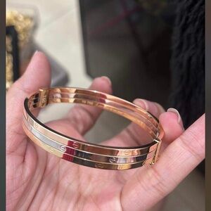 18k real yellow gold and white gold and rose gold. It is tri color bracelet.